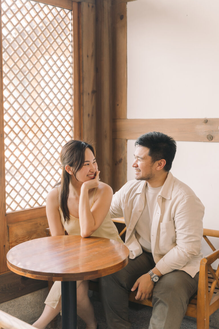 Couple smiling at each other during an indoor lifestyle photoshoot in Seoul