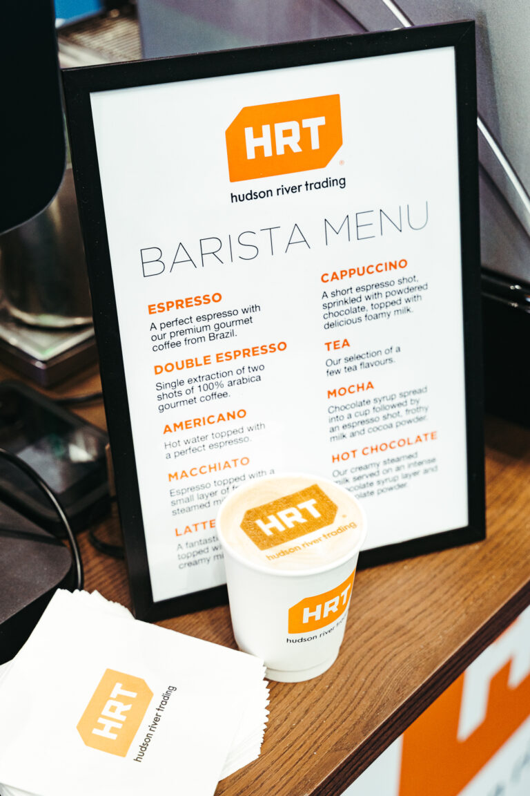 Branded barista menu and coffee cup displayed during a corporate event in Korea