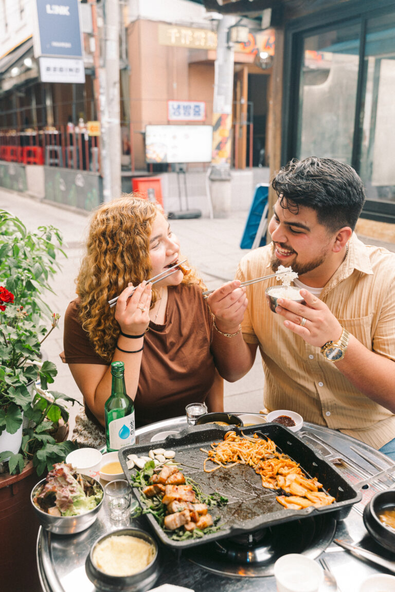Couple enjoying Korean food together during a candid Seoul photoshoot