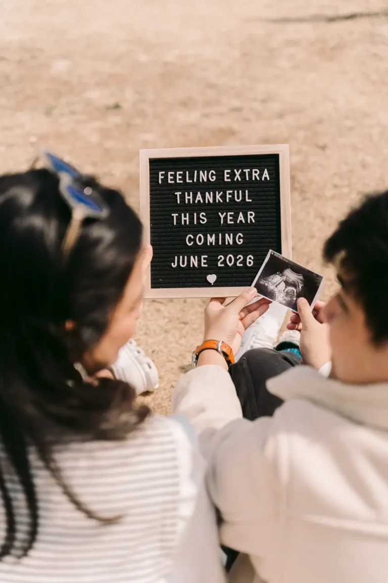 Expecting parents looking at an ultrasound photo beside their pregnancy announcement in Seoul