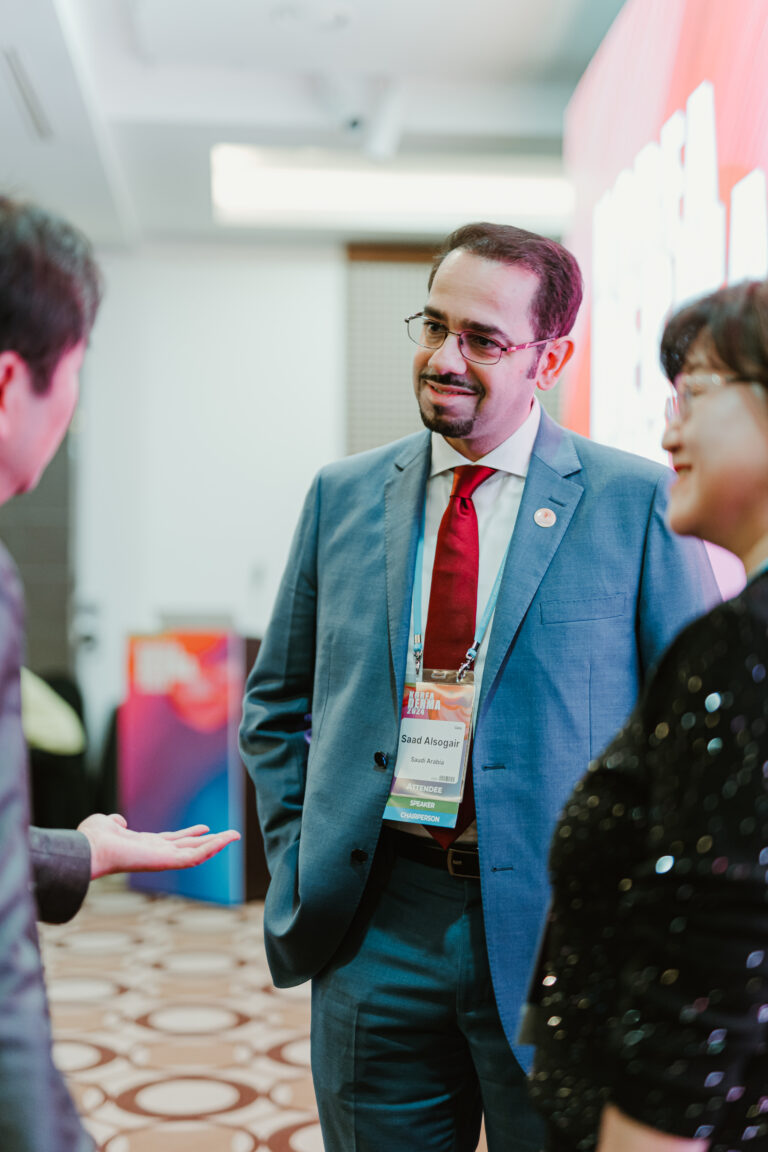 Conference attendee networking with guests during a professional business event in Korea