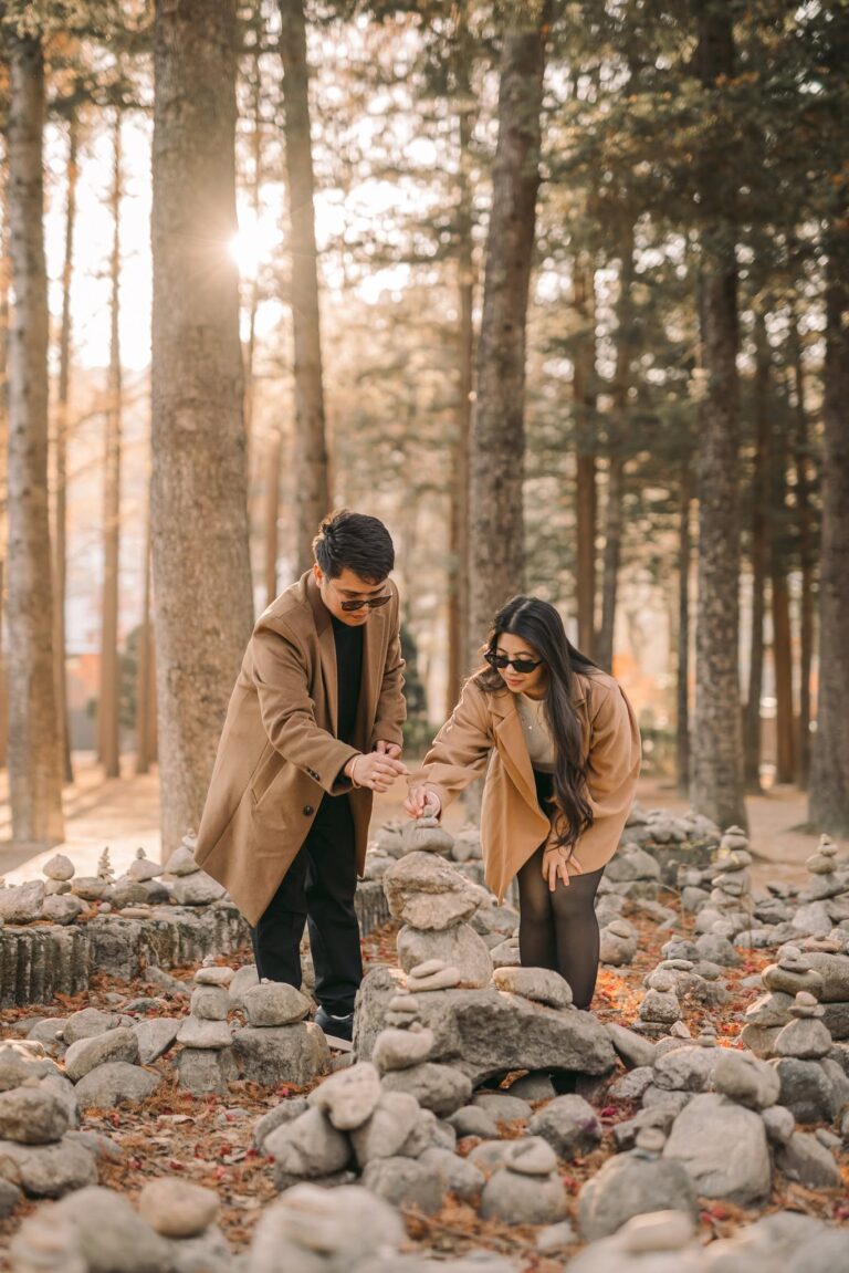 Couple exploring a wooded park during a candid Seoul photography session