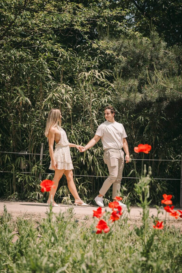 Couple walking hand in hand through a flower garden in Seoul