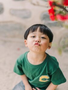 Young boy making a playful face during a candid outdoor photoshoot in Seoul