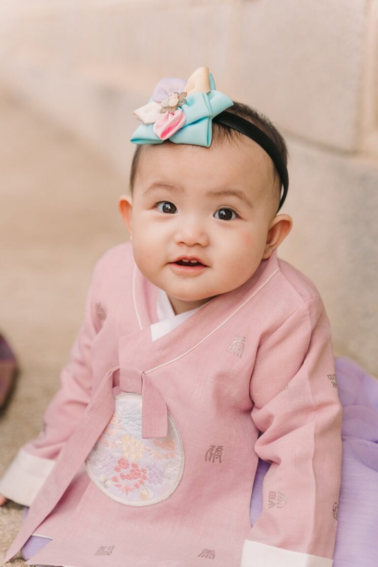 Baby girl wearing a pink traditional Korean hanbok during a Seoul portrait session