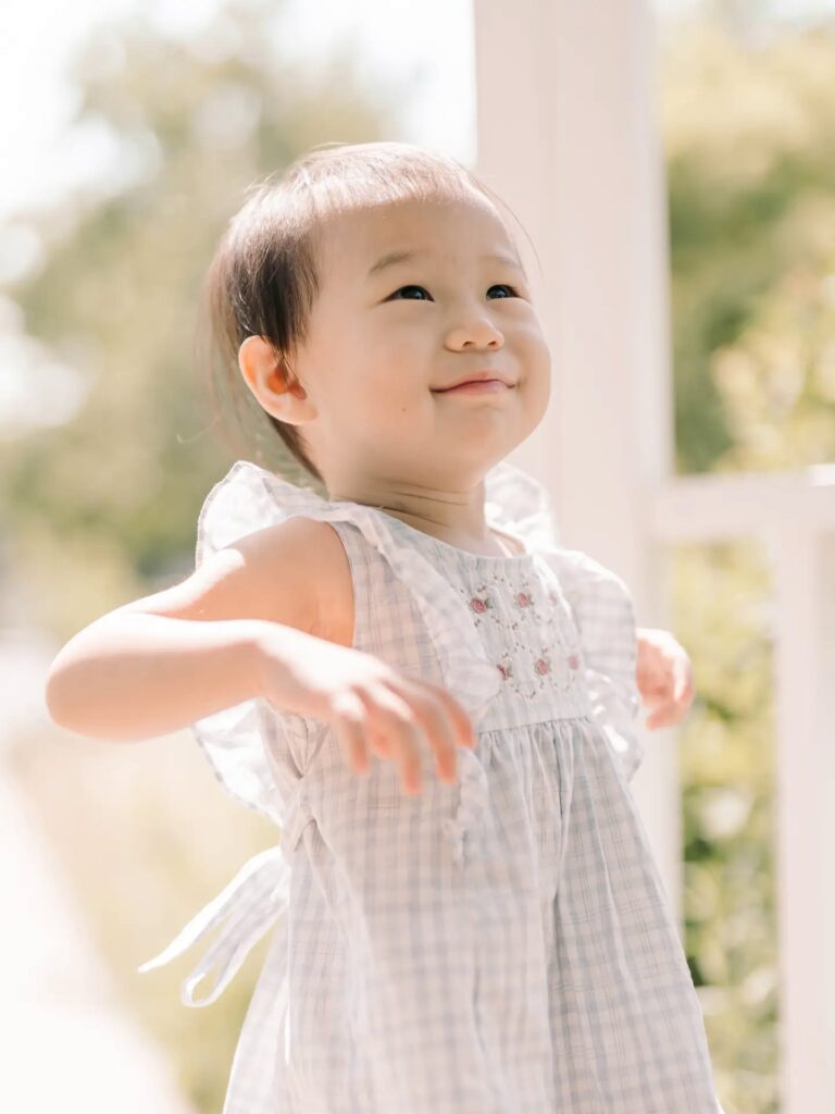 Smiling baby posing outdoors during a natural portrait session in Seoul