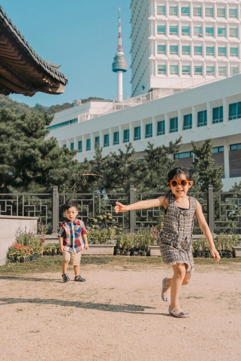 Mother and young child playing together during an outdoor family photoshoot in Seoul
