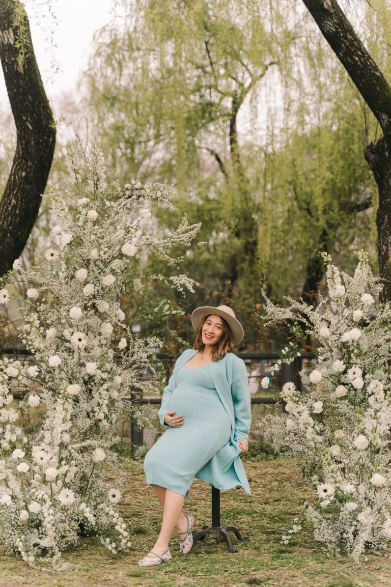 Pregnant woman posing among spring flowers during her maternity photoshoot in Seoul