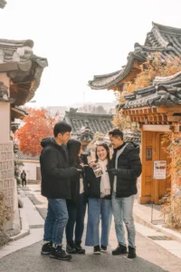 Expecting couple walking through a traditional hanok neighborhood during a Seoul maternity session