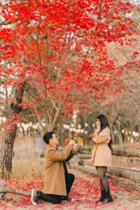Surprise marriage proposal beneath colorful autumn leaves in nami island