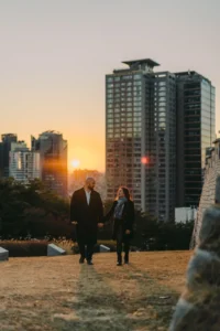 Couple photographed after their proposal against a warm Seoul sunset