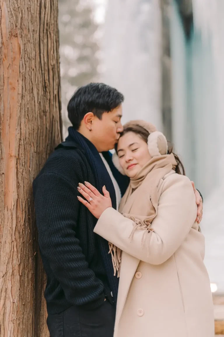 Engaged couple embracing during a romantic winter photography session in Seoul