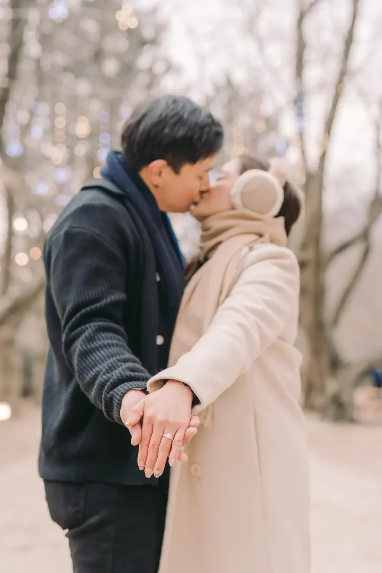 Engaged couple kissing while showing their new ring during a Seoul photoshoot