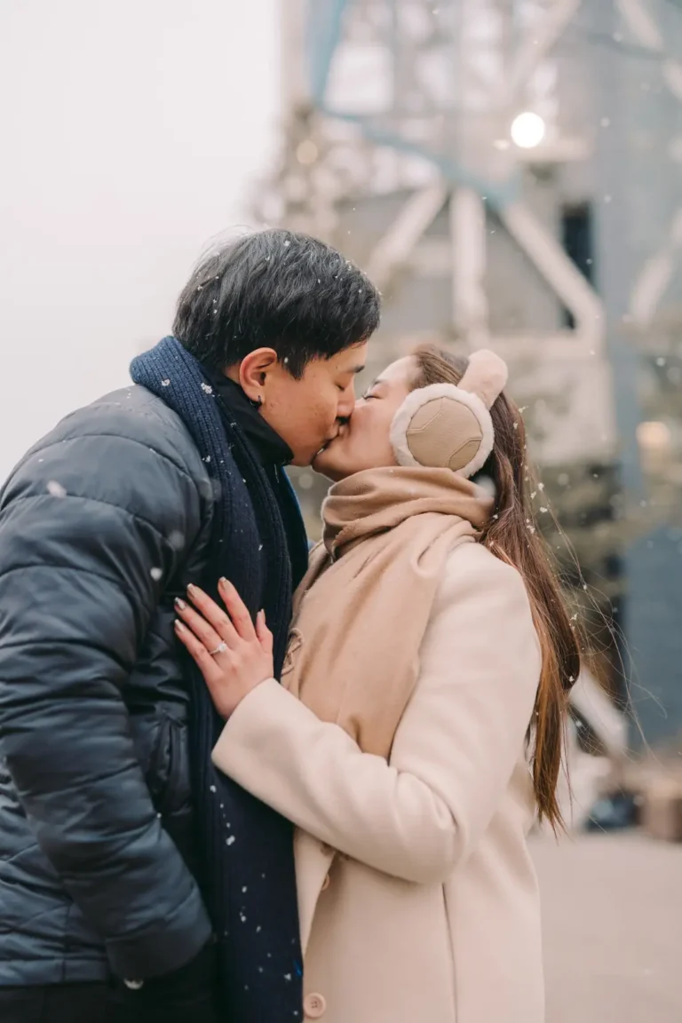 Couple kissing during a romantic winter engagement session in nami island