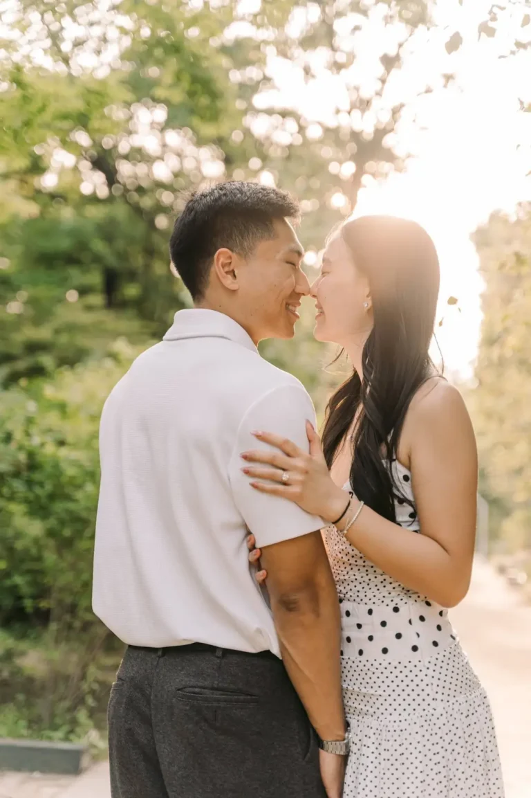Newly engaged couple kissing during a warm outdoor engagement session in Seoul