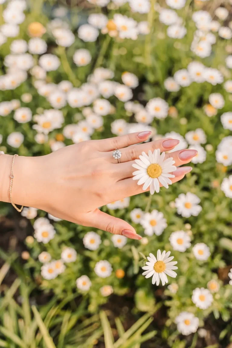 Engagement ring photographed against white flowers during a Seoul proposal session
