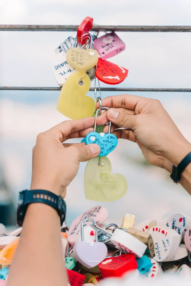Couple attaching a colorful love lock during a romantic Seoul photography session