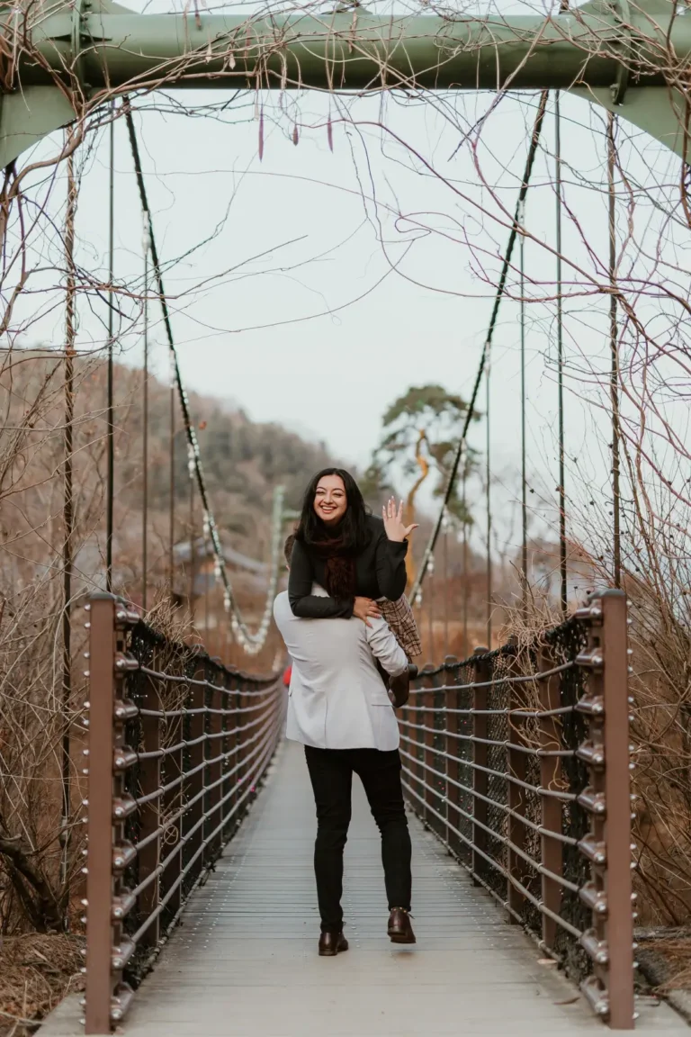 Newly engaged woman celebrating during a winter proposal session in Seoul