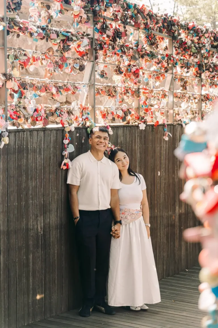 Couple posing together at a popular love lock location during their Seoul trip