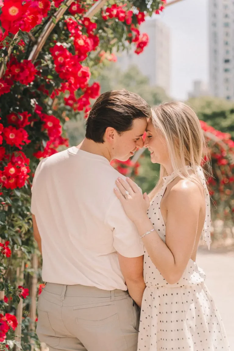 Engaged couple embracing beside red roses during their Seoul photography session