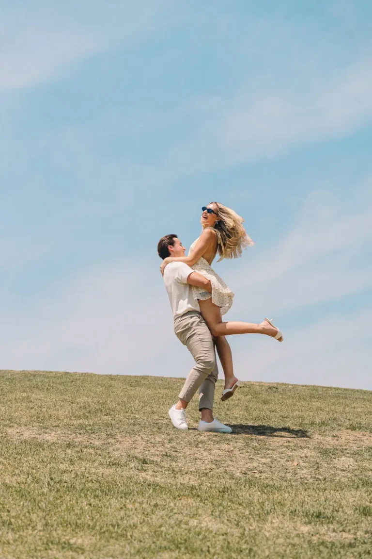 Engaged couple celebrating with a playful lift during an outdoor Seoul photoshoot