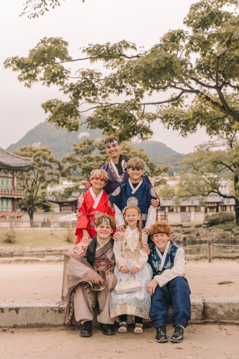 Family wearing traditional Korean clothing during a palace photoshoot in Seoul